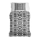 Therapy blanket and bedding set with black shapes.