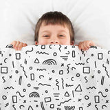 Therapy blanket bedding set, white with black shapes.