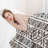 Therapy blanket and bedding set with black shapes.