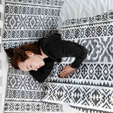 Therapy blanket and bedding set with black shapes.