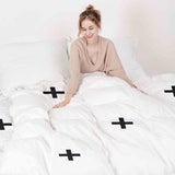 Therapy blanket and bedding set with black crosses.