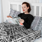 Therapy blanket and bedding set with black shapes.