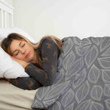 Therapy blankets and bedding set, grey with white palm leaves.