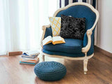 Health pillow, black with spiderweb pattern.