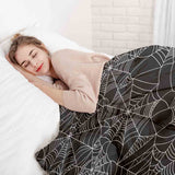 Therapy blanket bedding set, black with spiderweb pattern.