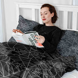 Therapy blanket bedding set, black with spiderweb pattern.