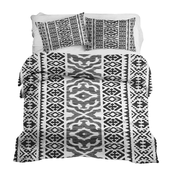 Therapy blanket and bedding set with black shapes.