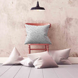 White health pillow with many small dots.