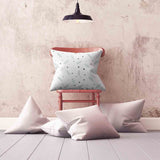 White health pillow with feathers and dots