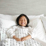 Therapy blanket and bedding set, white with many black arrows.