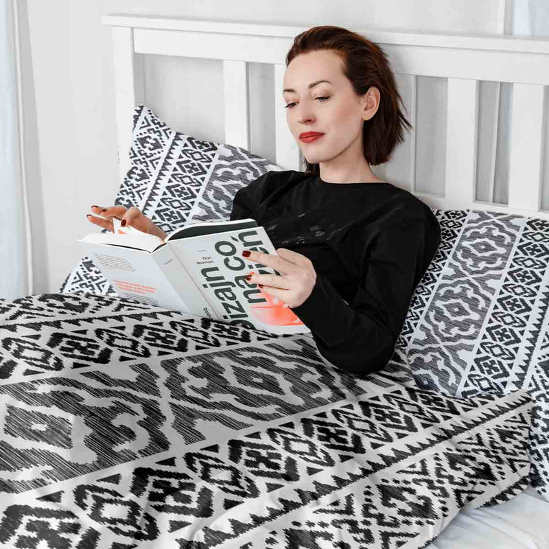 Therapy blanket and bedding set with black shapes.