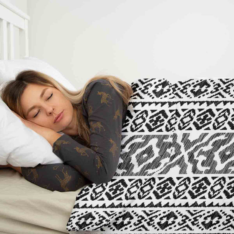 Therapy blanket and bedding set with black shapes.