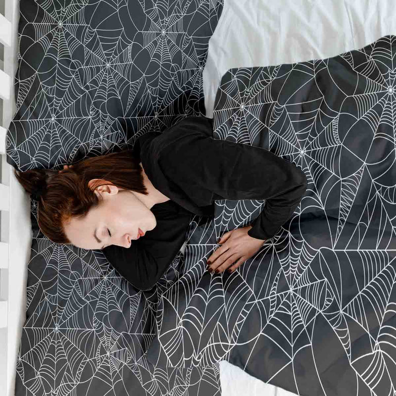 Therapy blanket bedding set, black with spiderweb pattern.